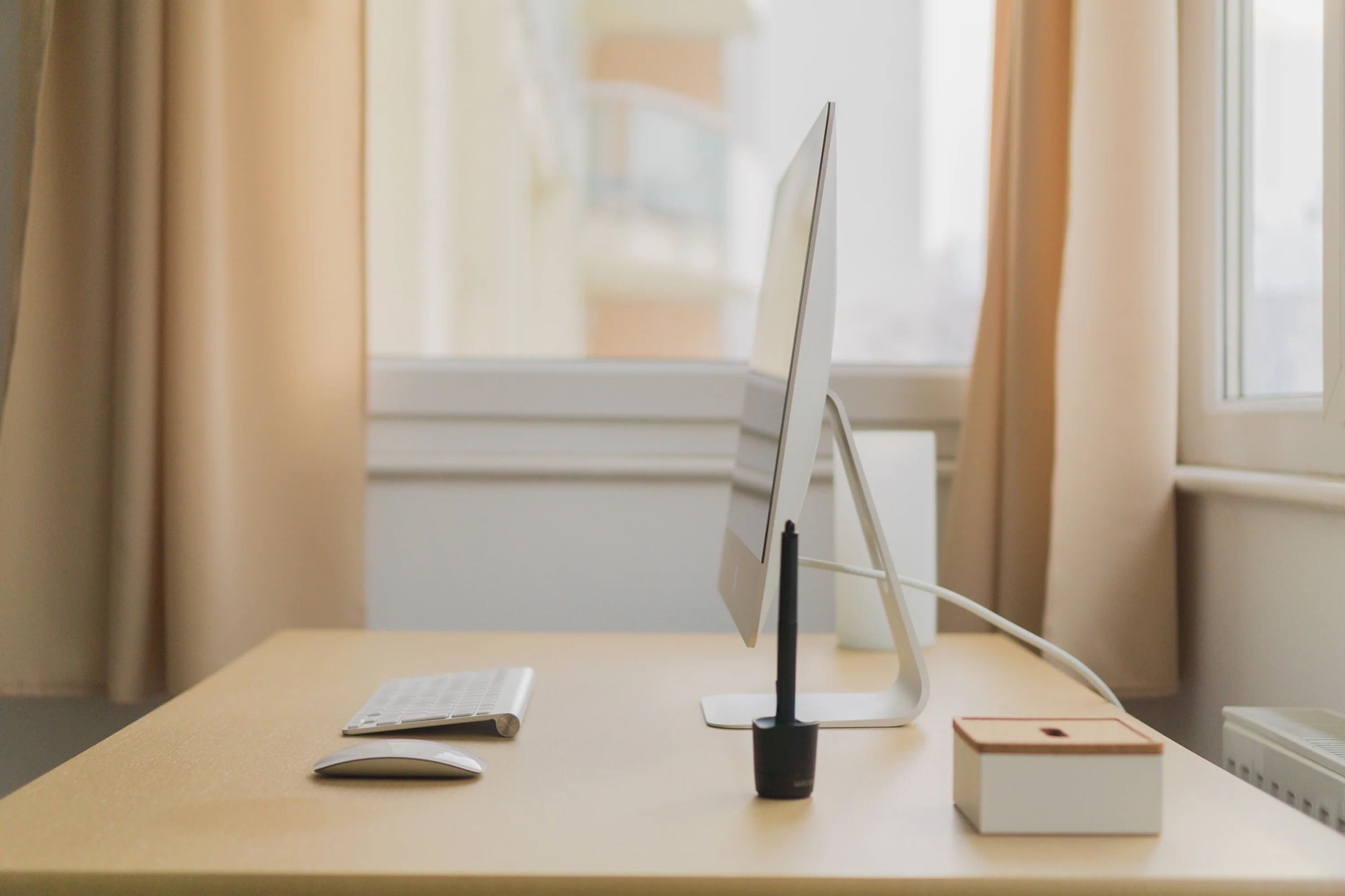 a side view of a computer monitor, keyboard, and mouse